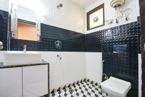 A bathroom with a white sink, a shower, and a toilet. - Fabhotel 19 West (New Delhi)