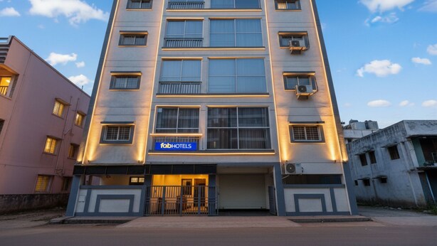 A multi-story building with a sign for 'fabHOTELS' at the ground level. - Fabhotel White House Inn (Pune)