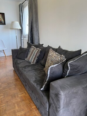 Relax in a cozy space with a comfortable sofa, modern chair, and floor lamp.