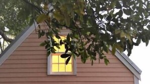 A two-story house with a porch, a front door, and a small window above the door. - Charming 1BR Cottage : Steps from Hemingway House & Old Town (Key West)