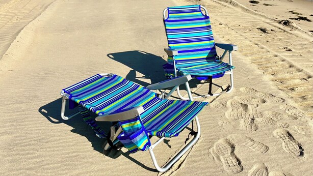 A beach with three striped lounge chairs and a sandy path. -   EXPLORE NEW SEABURY from our 2/2 Townhome - views + beach+ pool+ fireplace.  (Mashpee)