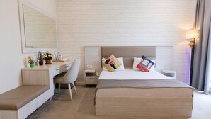 Una habitación de hotel con cama, escritorio y silla.