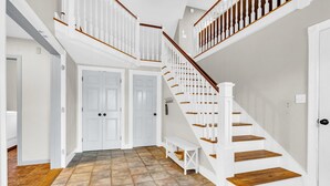A staircase with white railings and wooden steps, leading to an upper floor. - Spacious Home Close to Beaches! 3BR, Dog & Family Friendly, 30 Mins to Portland (Biddeford)
