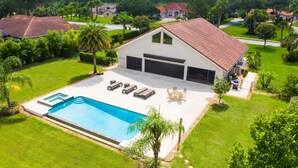 A house with a swimming pool, a covered garage, and a well-maintained lawn. - Swiss 105 - Lake Olsen (Clermont)