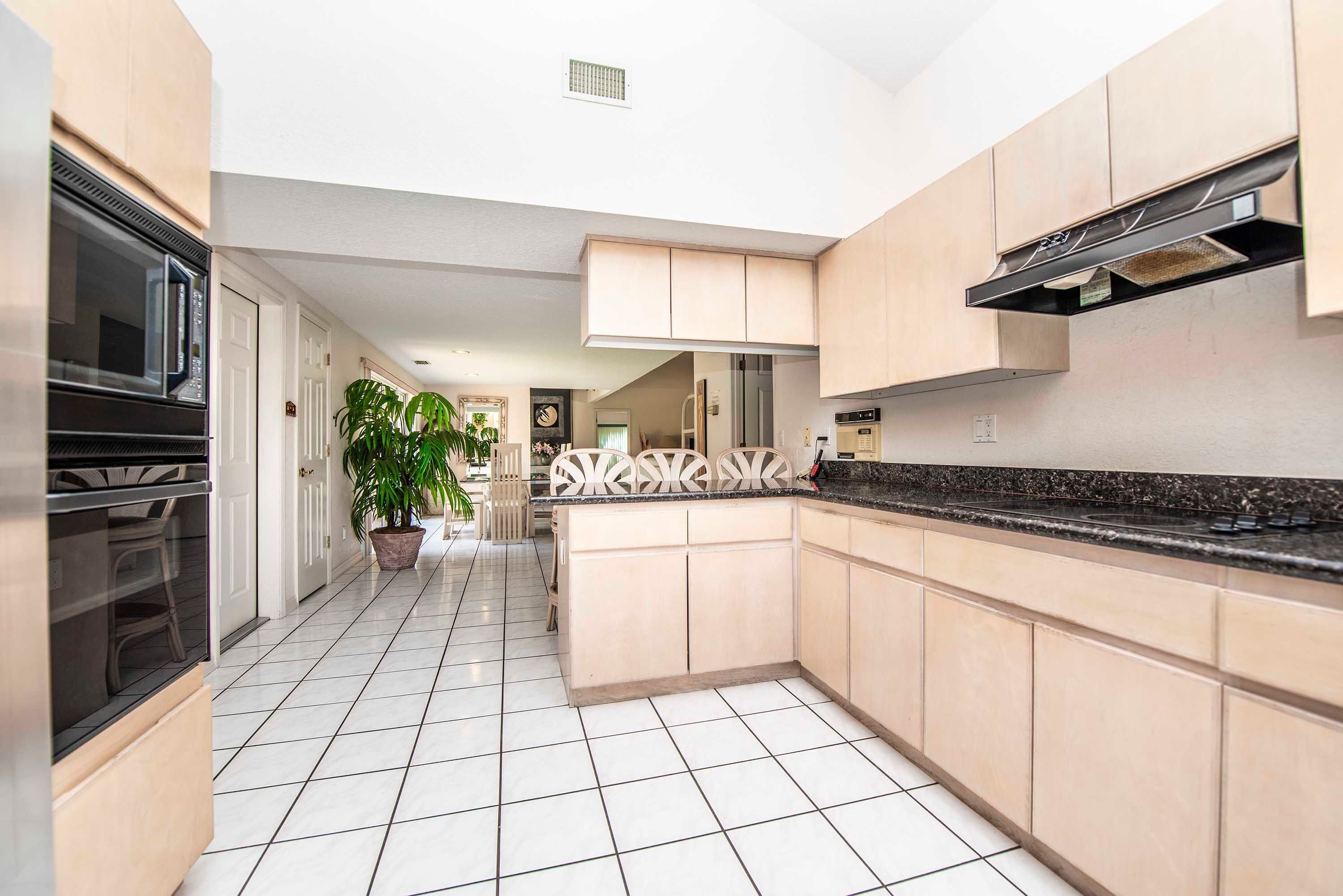 A modern kitchen with a microwave, stove, and cabinets.