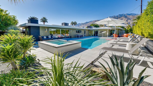 A modern pool area with lounge chairs, a hot tub, and a mountain backdrop. - 2 Mi to Downtown: Luxe Palm Springs Home! (Palm Springs)