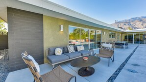 An outdoor patio with a sofa, chairs, and a table. - 2 Mi to Downtown: Luxe Palm Springs Home! (Palm Springs)