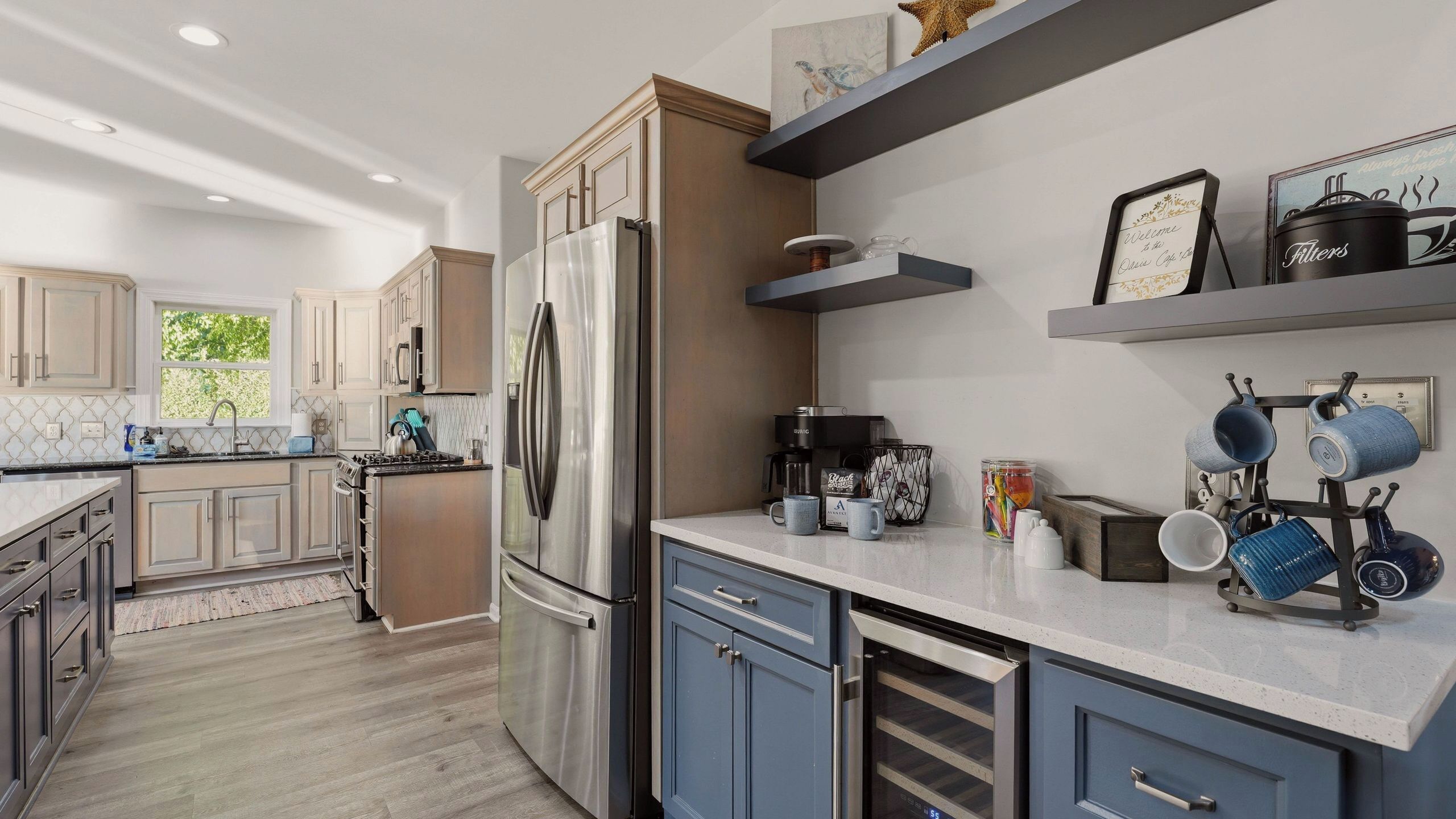 A modern kitchen with stainless steel appliances, a built-in oven, and a coffee maker.