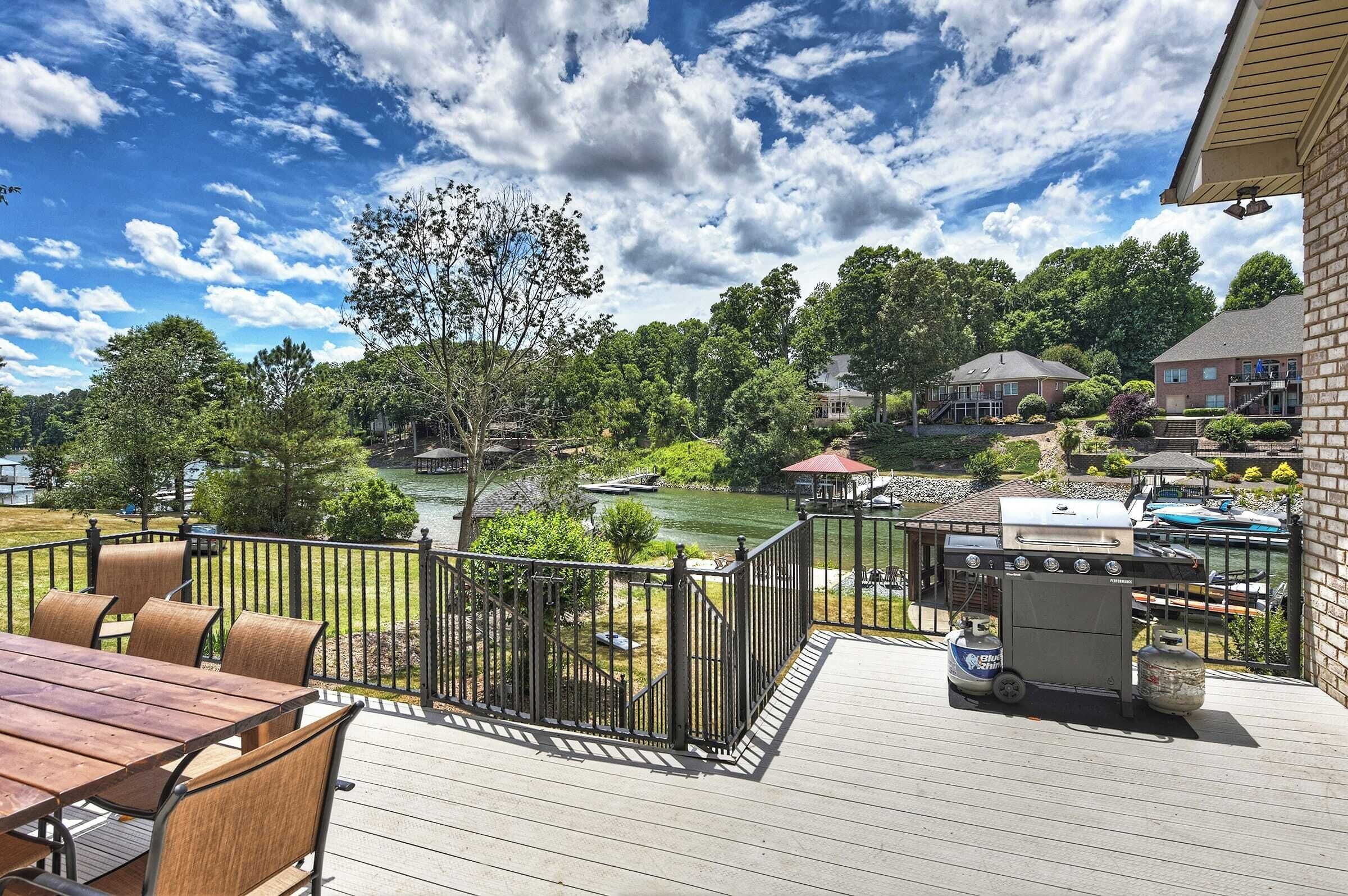 A deck with a grill and outdoor seating.