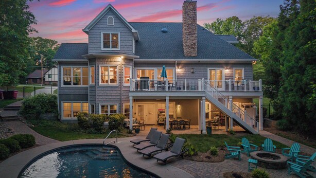 A two-story house with a large deck, a swimming pool, and outdoor seating. - Making Waves by Avantstay Sleeps 20 + Pool (Denver)