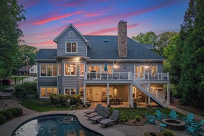 A two-story house with a large deck, a swimming pool, and outdoor seating. - Making Waves by Avantstay Sleeps 20 + Pool (Denver)