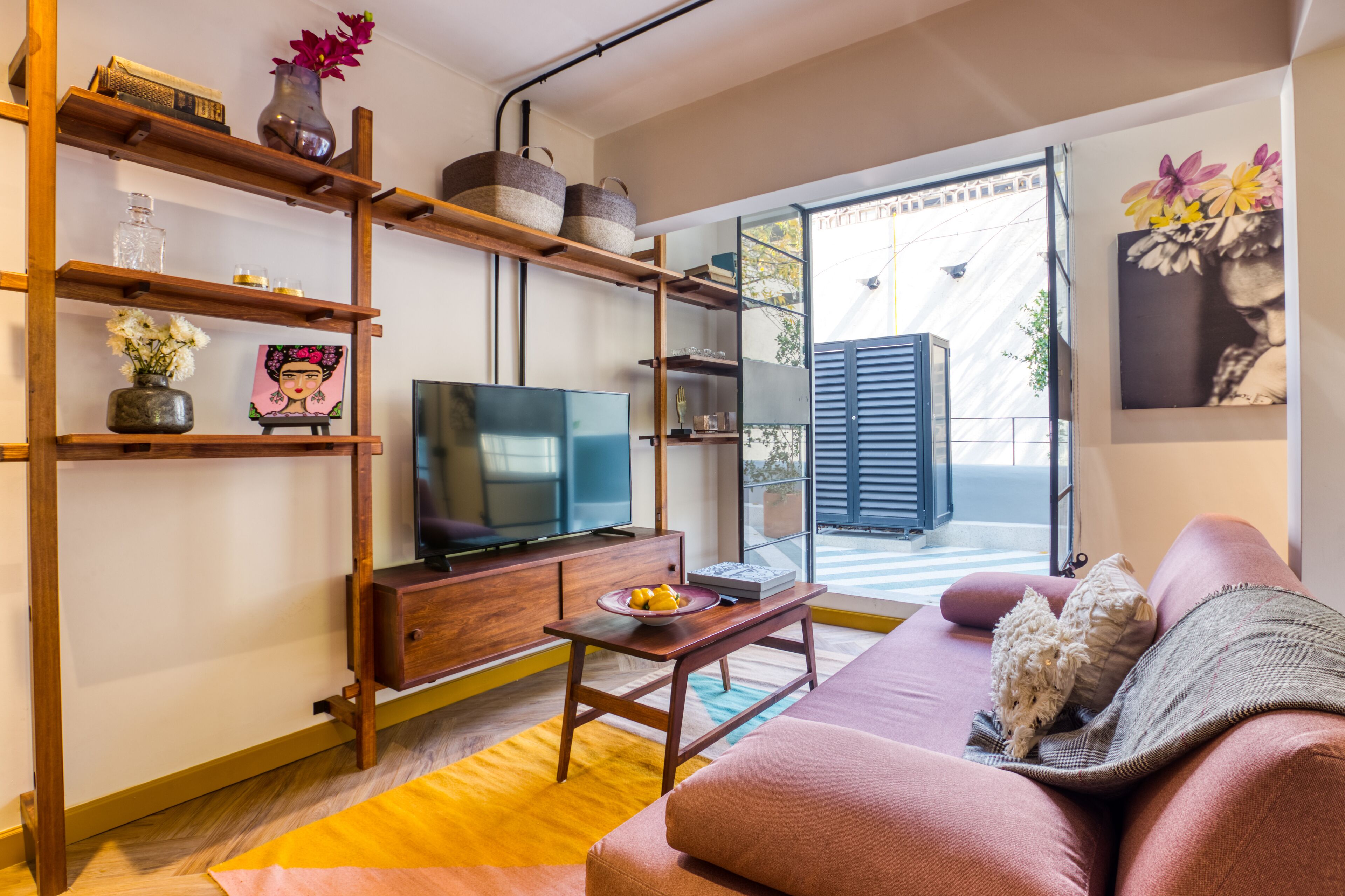 Un salon moderne avec un meuble TV en bois, un canapé et une table basse.