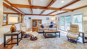 A living room with a wooden ceiling, a sofa, a recliner, a coffee table, and a bookshelf. - Fishing & Rafting Retreat: 7 Mi to Rogue River! (Grants Pass)