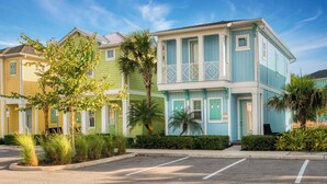 A row of colorful, two-story buildings with balconies, likely part of a hotel or resort.