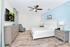 A bedroom with a bed, nightstands, a dresser, a ceiling fan, and artwork on the walls. - Sea Blue Villa near Disney | Margaritaville & Waterpark Access - 3164CS (Kissimmee)