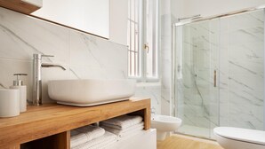 A modern bathroom with a large vessel sink, a glass shower enclosure, and a toilet. - Golden Teal apartment (BERGAMO)