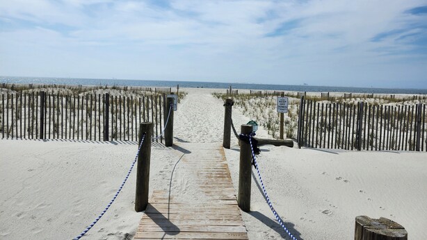 A wooden boardwalk leading to a beach with a sign indicating 'Keep Off Dunes'. - Labor Day is open! SURFS UP! Family friendly. Finance with Affirm! (Dauphin Island)