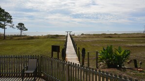 A wooden pier leading to a beach with a bench and a railing on the left. - Labor Day is open! SURFS UP! Family friendly. Finance with Affirm! (Dauphin Island)