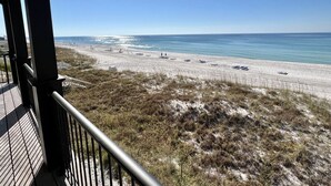 A beach view from a balcony with a railing, sandy beach, and ocean. - Foresight: Stunning Gulf Front Home, Private Pool w/ Spa, Guest House (Panama City Beach)
