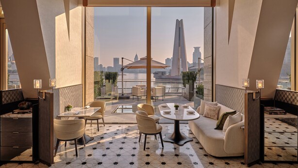 A modern hotel room with a large balcony, a dining area, and a sofa. - Regent Shanghai On The Bund (Shanghai)