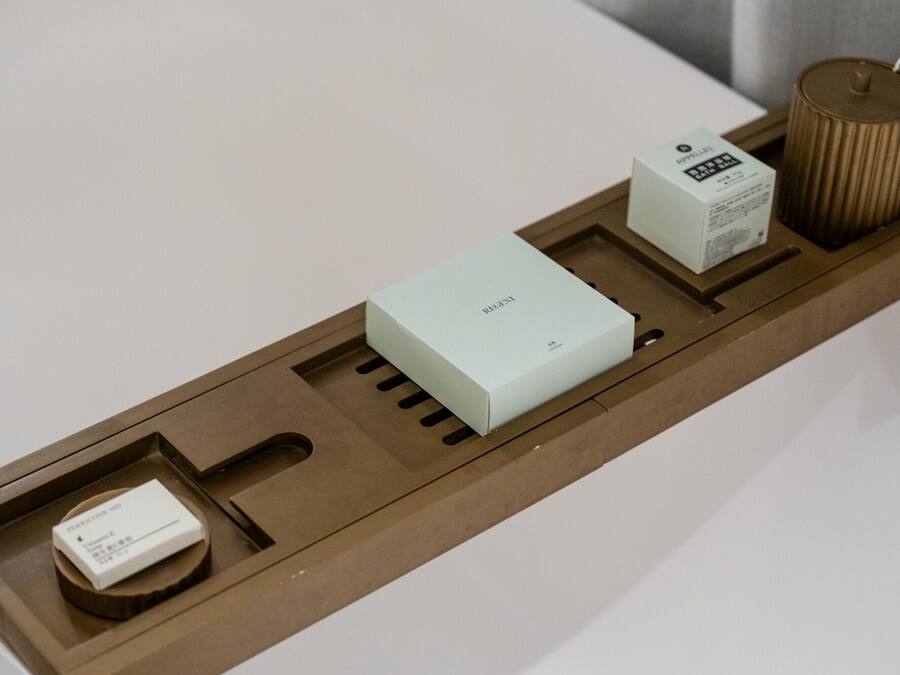 A tray with a light blue box labeled "RIGEL," a white box with text, and a cylindrical container.