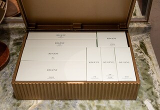 A box of Regent personal care items including a shaving kit, toothbrushes, and a cologne set.