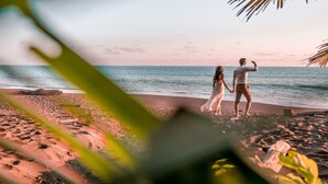A couple standing on a beach with the ocean in the background. - Finca Exotica ecolodge (Puerto Jiménez)