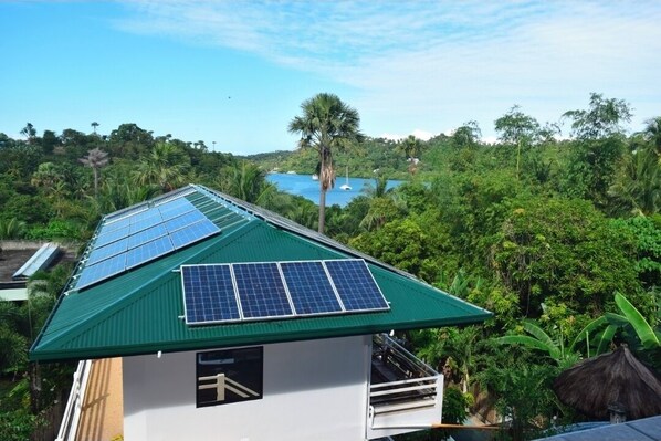 A house with a green roof and solar panels. - Jalyn's Resort & Restaurant (Puerto Galera)