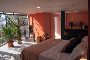 Relax in comfort with a large bed, potted plant, and balcony access.