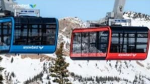 A cable car system with cabins labeled "snowbird" against a snowy mountainous backdrop. - Iron Blosam Lodge at Snowbird with all the amenities you want. (Sandy)