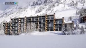 A multi-story hotel with a modern design, situated in a snowy mountainous area. - Iron Blosam Lodge at Snowbird with all the amenities you want. (Sandy)