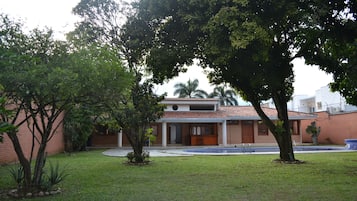 Enjoy a tranquil retreat in this two-story home surrounded by a lush lawn and mature trees.