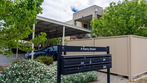 A street sign for 9 Kerry Street with a mailbox and a parking area in front. - Tasha's Apartments on Kerry (Athol Park)