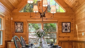 A wooden dining room with a high ceiling, a chandelier, and a large window. - Amazing Overlook Mtn Cabin Near DT Blue Ridge (Blue Ridge)