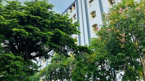 A multi-story building with a modern architectural design, featuring large windows and balconies. - One Residence (Khlong Luang)