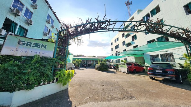 An apartment complex with a sign reading "GREEN APARTMENT." - Green Apartment Kaset (Bangkok)