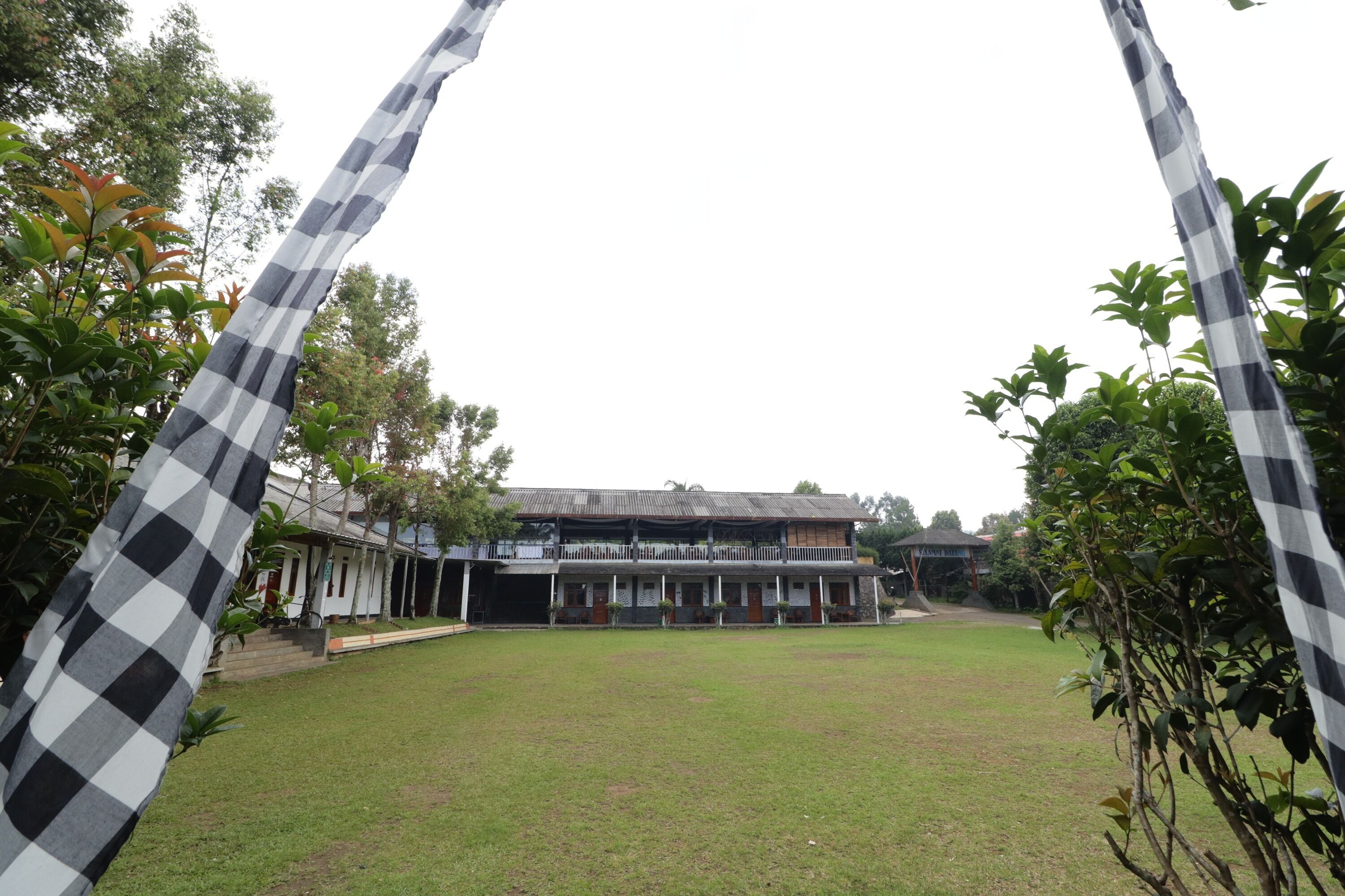 A building with a traditional architectural style, featuring a flat roof and a symmetrical facade.