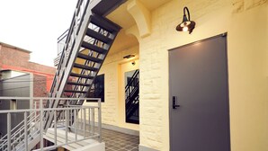 A modern building with a staircase, a door, and a light fixture.