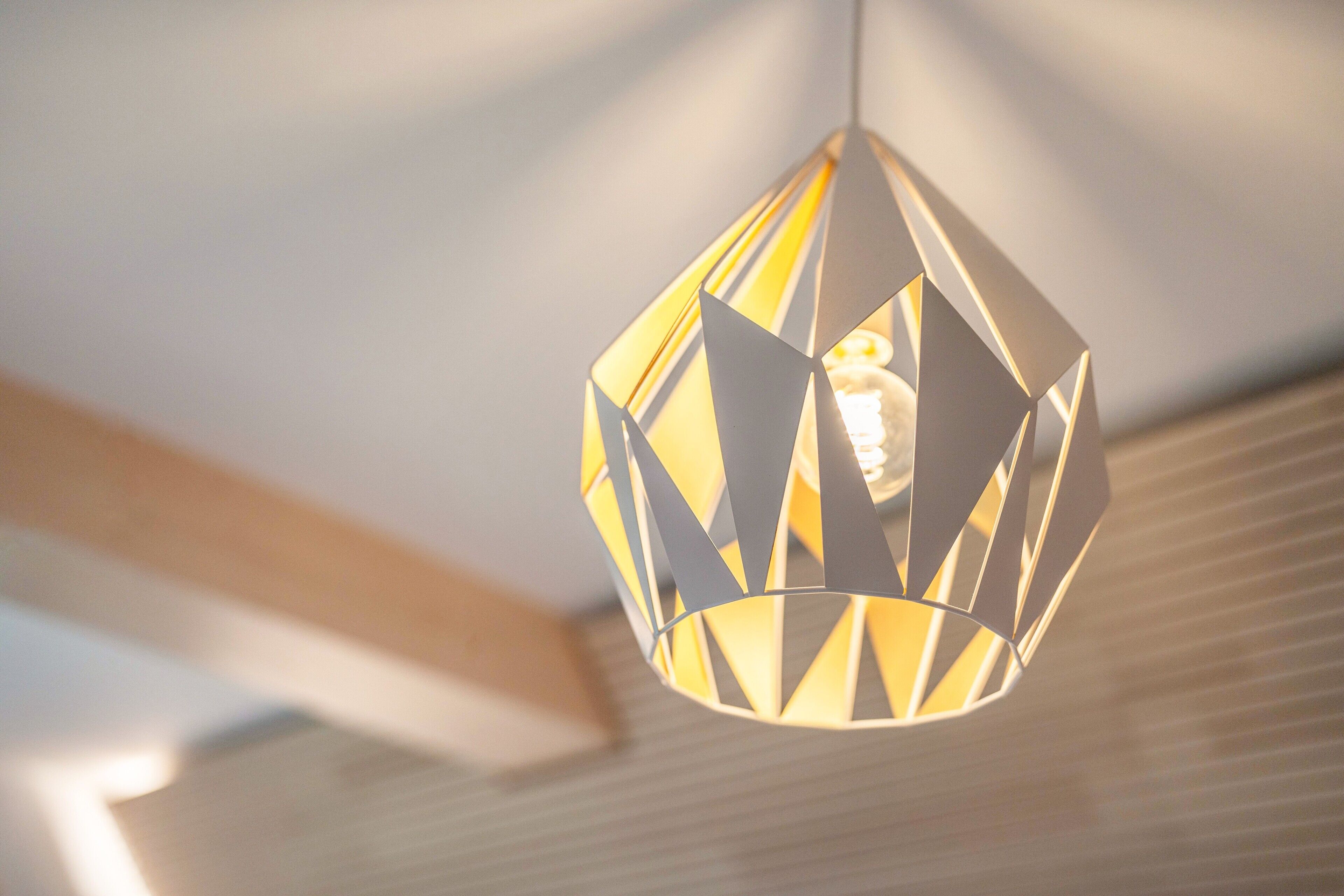A geometric pendant light fixture with a visible bulb.