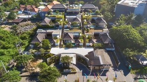 An aerial view of a resort with multiple buildings, a central pool, and a landscaped area with trees and pathways. - Peaceful 16BR Villa W/ Pool in Bali, Bali Villa 2209 (Bali)