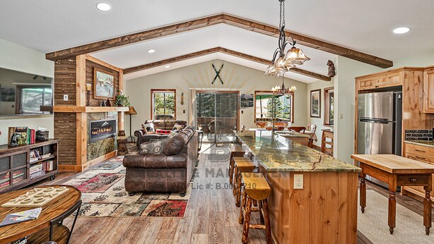 A spacious kitchen with a large island, wooden cabinetry, and a high ceiling with exposed beams. - Overlooking the Slopes of Diamond (1236ST) (Incline Village)