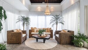A spacious living room with a large sofa, two armchairs, a coffee table, and two potted palm trees. - Beautiful 6BR Villa W/Pool & Spa room, Bali villa 2238 (Bali)