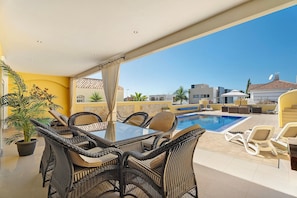 An outdoor pool area with wicker furniture and a clear view of the surrounding buildings. - Vacation Villa 'Romano' with Sea View, Private Pool and Wi-Fi (Costa Adeje)