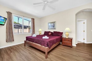 Relax in a cozy space with a comfortable bed, bedside tables, and a ceiling fan.