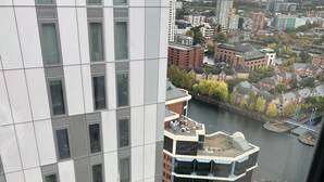A high-rise building with a modern design, featuring a mix of glass and metal facade.