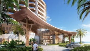 A modern hotel with a curved entrance canopy, palm trees, and a luxury car parked outside. - ZhouShan Poly Senbo Nature Park and Resort (Zhoushan)