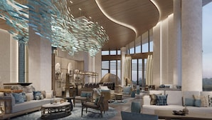A spacious lobby with a modern design, featuring a large seating area with sofas and chairs, a central coffee table, and a unique hanging light fixture. - ZhouShan Poly Senbo Nature Park and Resort (Zhoushan)
