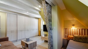A bedroom with a bed, a nightstand, a TV, a wardrobe, and a window. - Holiday Apartment "Gite Béthanie" with Mountain View, Private Wooden Terrace & Wi-Fi (Steige)
