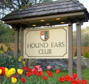 A sign for the Hound Ears Club with a logo above the text.