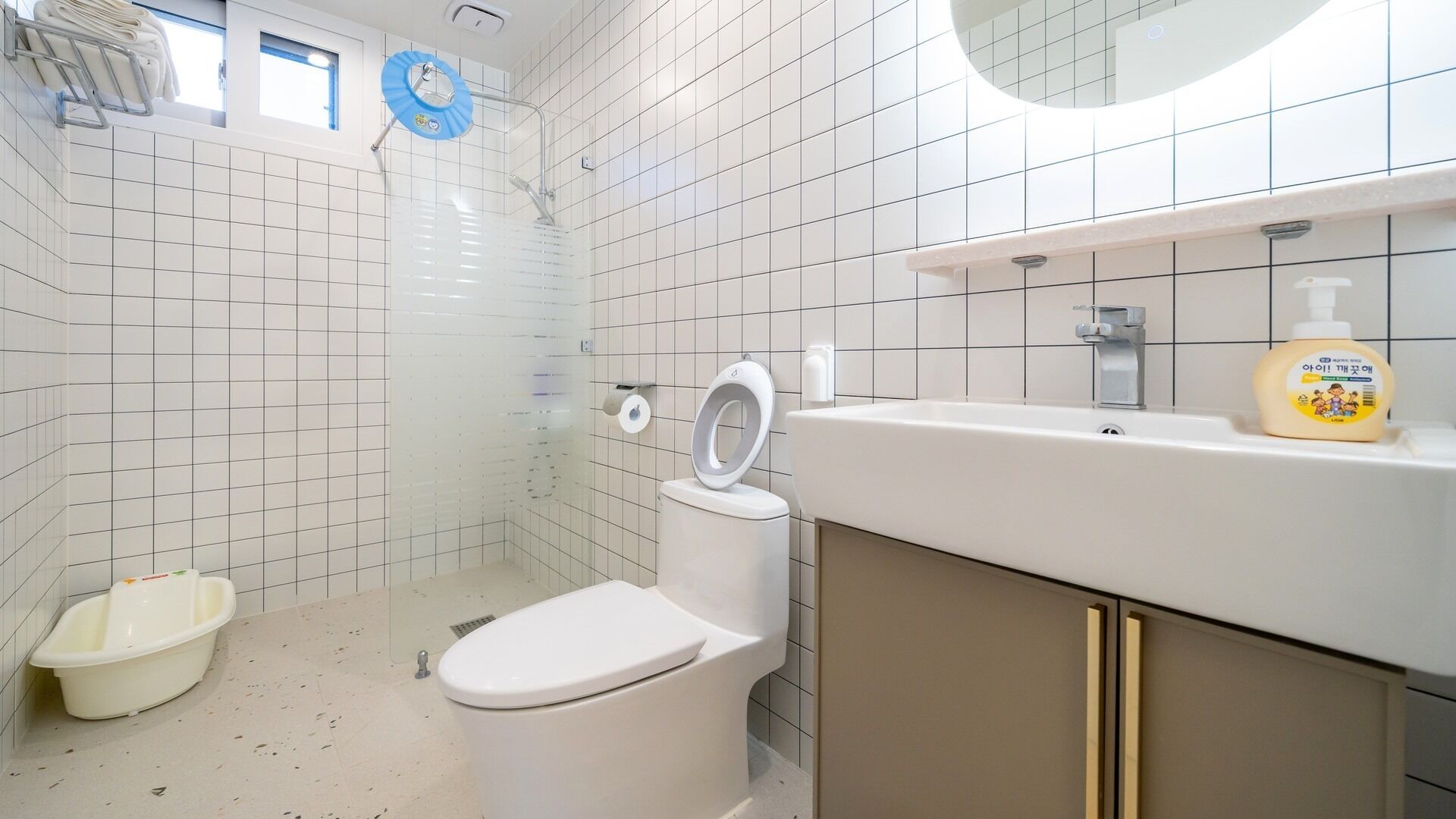 Une salle de bain équipée de toilettes, d’une douche, d’un lavabo et d’un savon.
